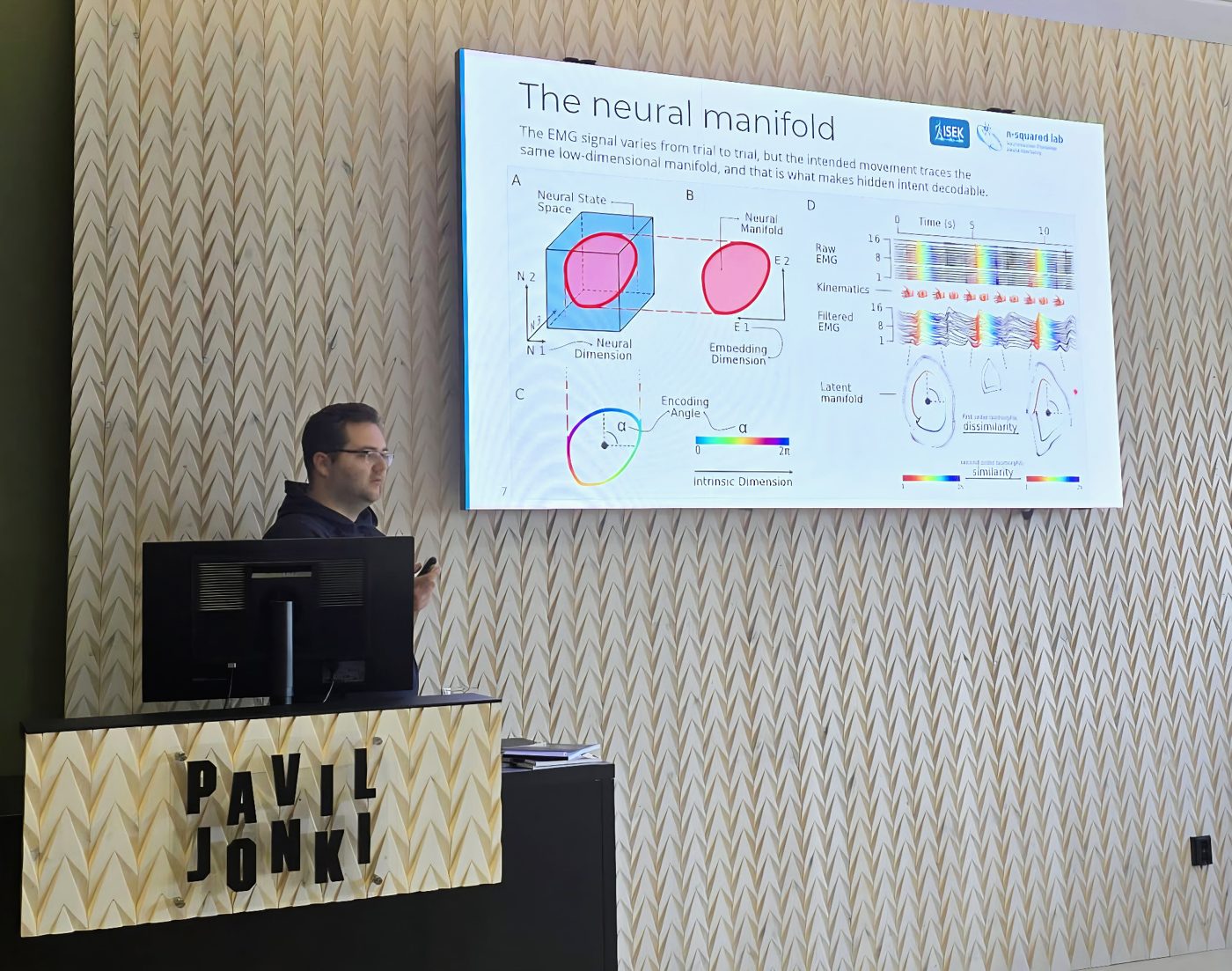Raul C. Sîmpetru at the lectern at ISEK 2026, presenting a slide titled The neural manifold