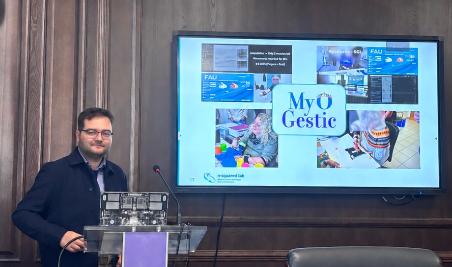 Raul C. Sîmpetru at a lectern at Georgian Technical University, presenting MyoGestic